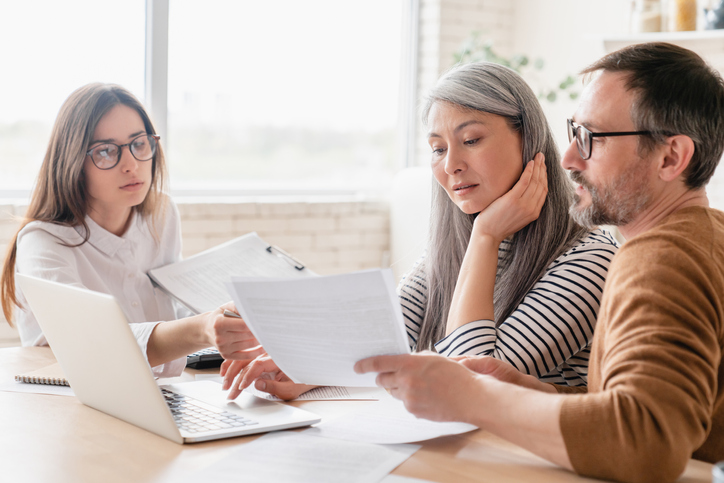 A financial advisor meets with a couple to explain how to convert a rental property to a primary residence.